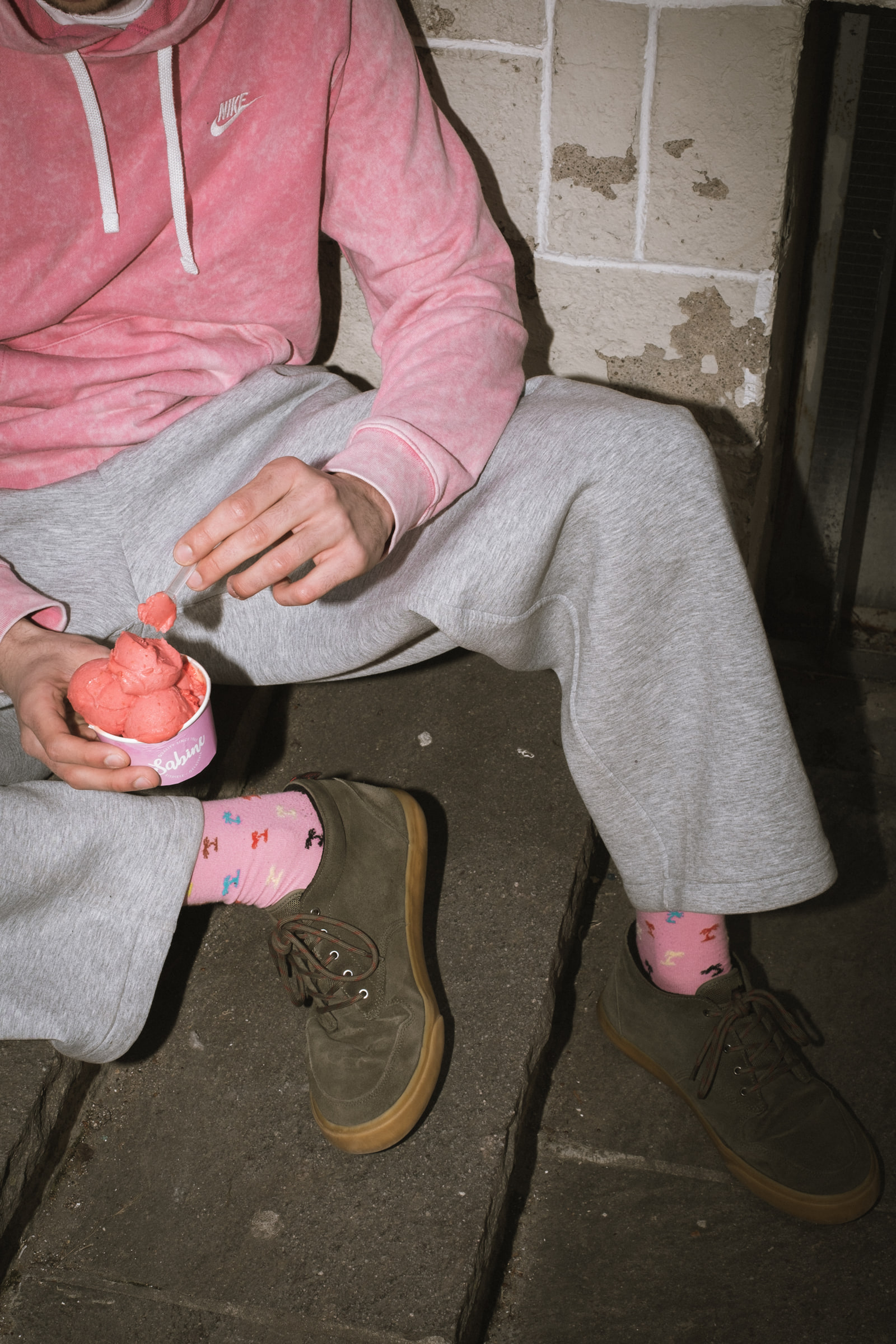 Ein Becher Eis auf der Treppe vor der Eisdiele
